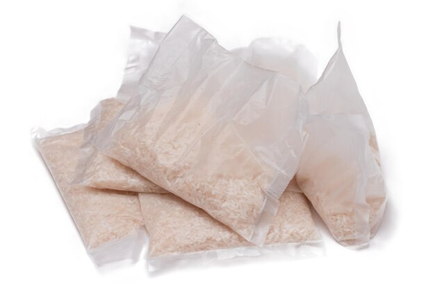 Пластиковые пакеты с белым длиннозерновым рисом, изолированным на белом