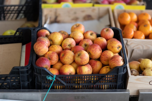 Plastic basket with apples on the market