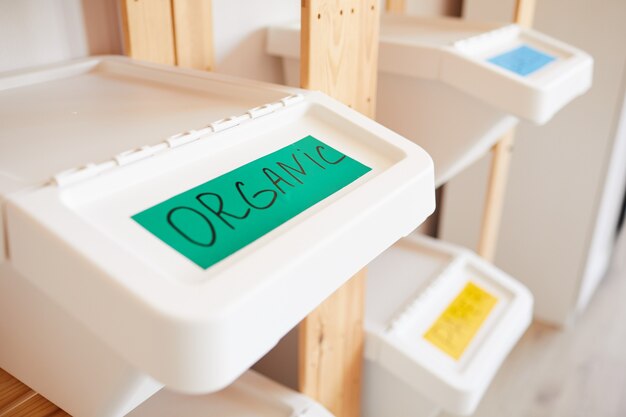 Photo plastic bin labeled for organic waste, home sorting and storage concept