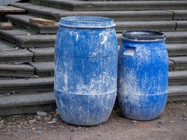 Plastic blue barrels on the construction site.