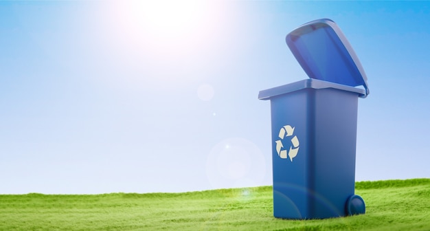 A plastic blue container stands on green grass against blue sky