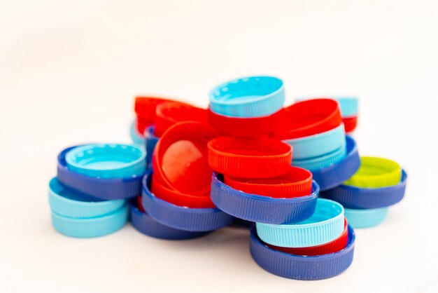 Plastic Bottle Caps In Different Colours. A Pile Of Plastic Bottle Covers.  Isolated On White Background. Stock Photo, Picture and Royalty Free Image.  Image 81597458.