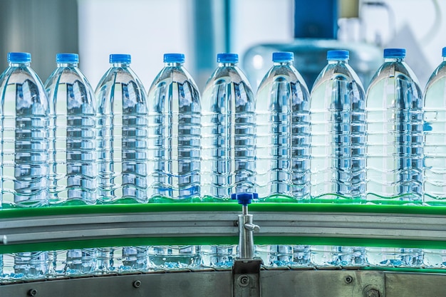 プラスチックボトルが流れ込んで 飲み物と清潔な水を 携帯水工場に運ぶ
