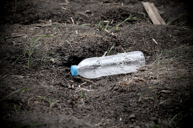 plastic bottle garbage on the soil ground  that can recycle