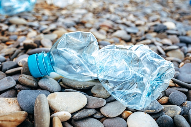 Plastic bottle trash left on a beach close up