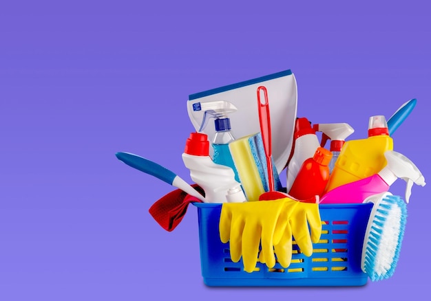 Plastic bottle with household chemicals and bucket on blue background