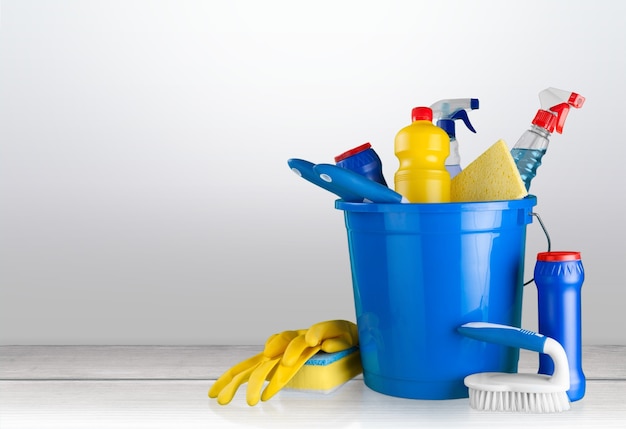 Plastic bottles, cleaning sponges and gloves  on background