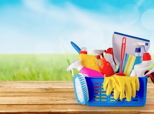 Plastic bottles, cleaning sponges and gloves on blue background