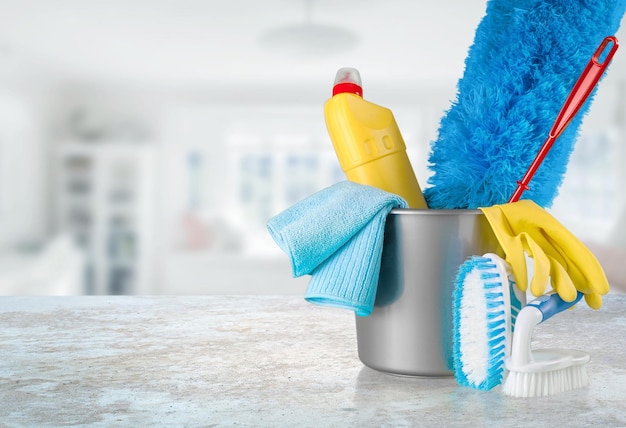 Plastic bottles, cleaning sponges and gloves in bucket