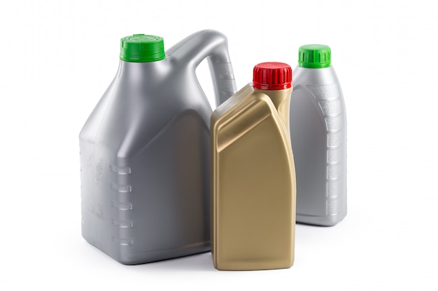 Bottiglie di plastica dagli oli dell'automobile isolati su bianco