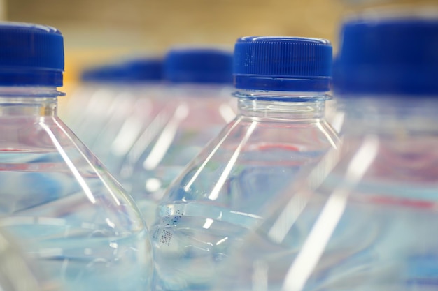 Plastic bottles of soft drink on table