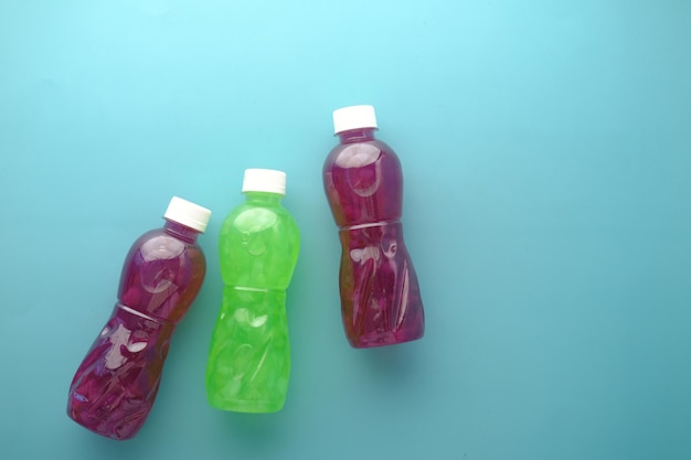 Plastic bottles of soft drink on table