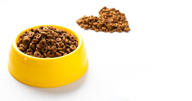 plastic bowl full with dry dog food isolated on white background Top view grain pet food with copy