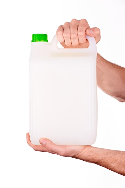 Plastic canister in hand on white background