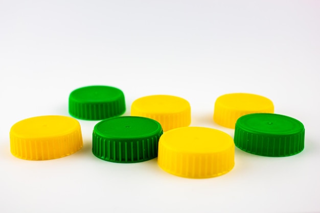 Plastic caps are green and yellow Plastic caps from packaging bottles