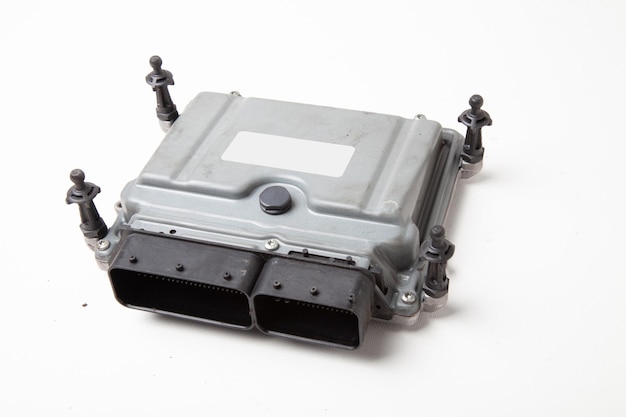 A plastic car engine control unit with metal elements on a white isolated background is the back center of the various subsystems components and assemblies Auto repair shop for sale