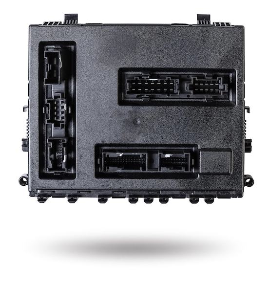 Plastic car engine control unit with metal elements on a white isolated background is the connecting center of various subsystems units and assemblies Monitoring the state of the moment Spare part