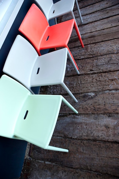 Photo plastic chairs on a wooden floor in a courtyard