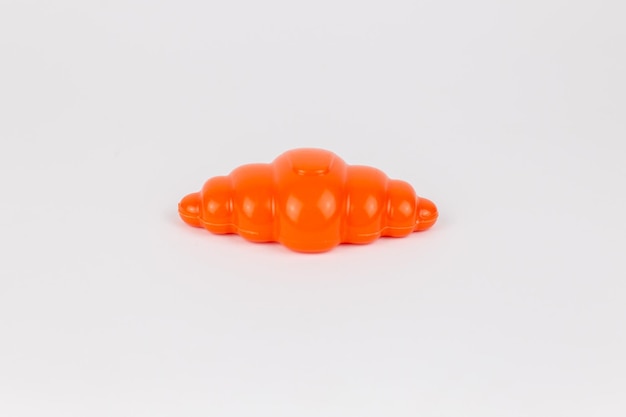 Plastic children39s toy French croissant on a white background