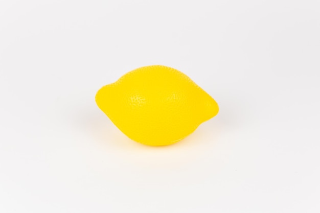 A plastic children39s toy lemon on a white background