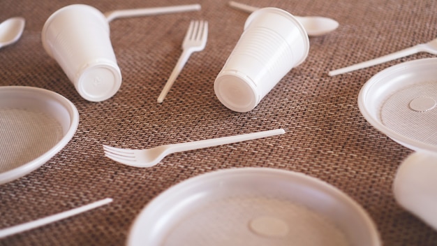 Plastic collection on beige background. Concept of Recycling plastic and ecology. Flat lay, top view