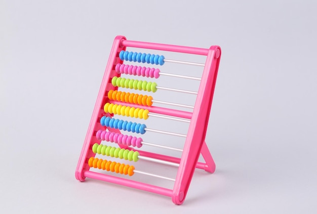 Photo plastic colored abacus on a gray background counting education economy business and finance concept