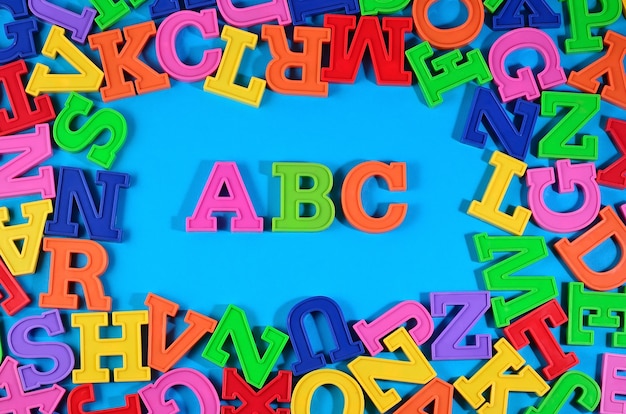 Plastic colored alphabet letters ABC on a blue background