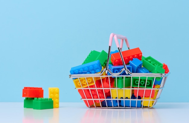 Plastic colorful building blocks in a miniature metal shopping cart educational game for children