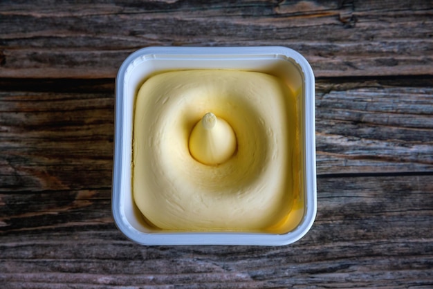 A plastic container filled with vegetable oil spread