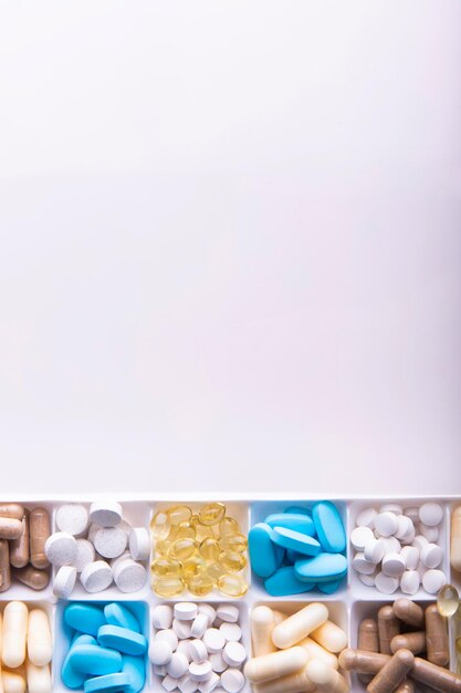 Photo plastic container with pills on white background