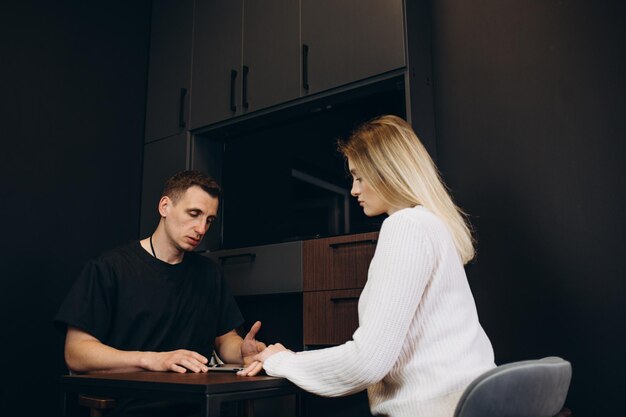 Plastic cosmetic Surgeon Consults Woman about Facial Lift Surgery He Draws Arrows on Digital Tablet Computer Screen Showing Types of Facelift and Nose Correcting Procedures Available for Her