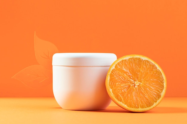 Photo plastic cream container with orange half