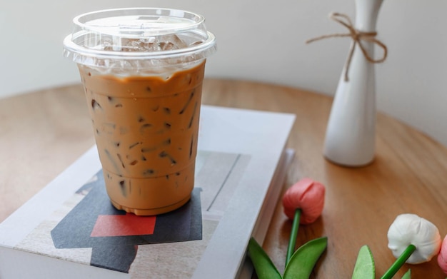 Plastic cup of cold espresso coffee on a coffee shop table