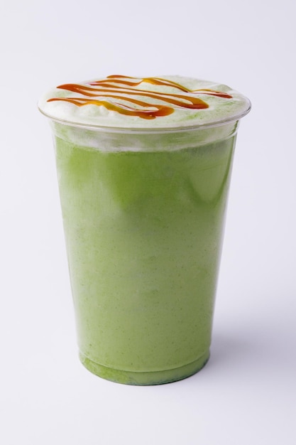 Plastic cup of fresh matcha latte