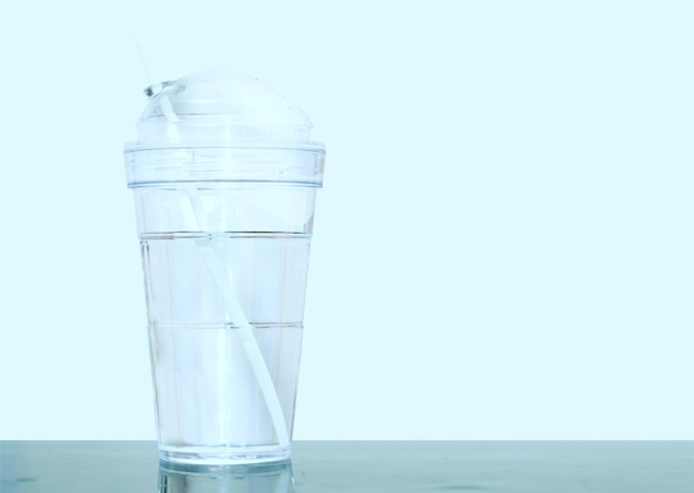 Plastic cup with water and straw