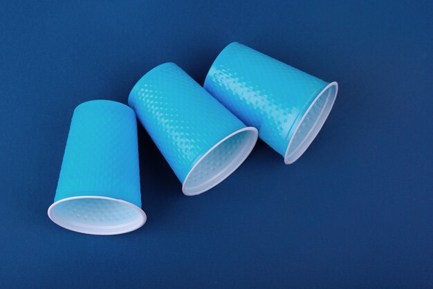 Plastic cups on a blue