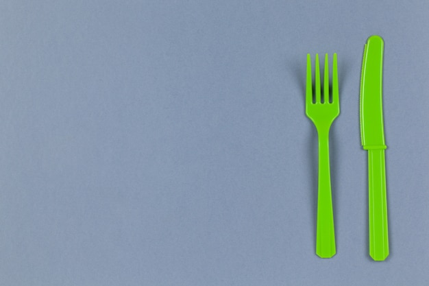 Plastic cutlery on blue background