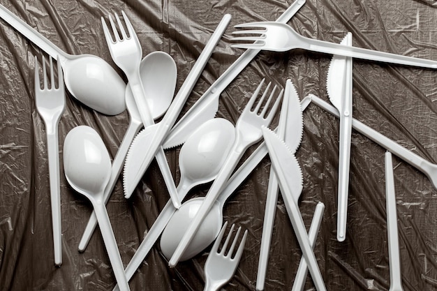 Plastic cutlery forks spoons and knives Pollution of environment with plastic and microplastics