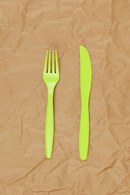 Plastic cutlery on paper background