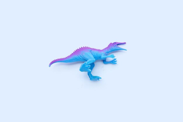 Plastic dinosaur toys on white background Top view