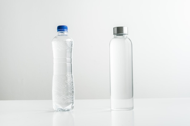 Plastic disposable water bottles against reusable glass