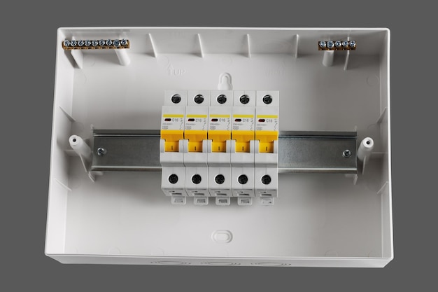 Photo plastic distribution board electrical board closeup isolated on light gray background