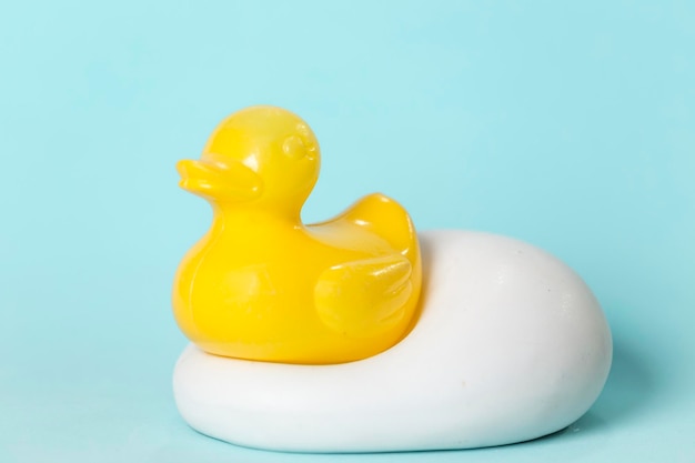 Plastic duckling for the bathroom placed on a ceramic soap dish