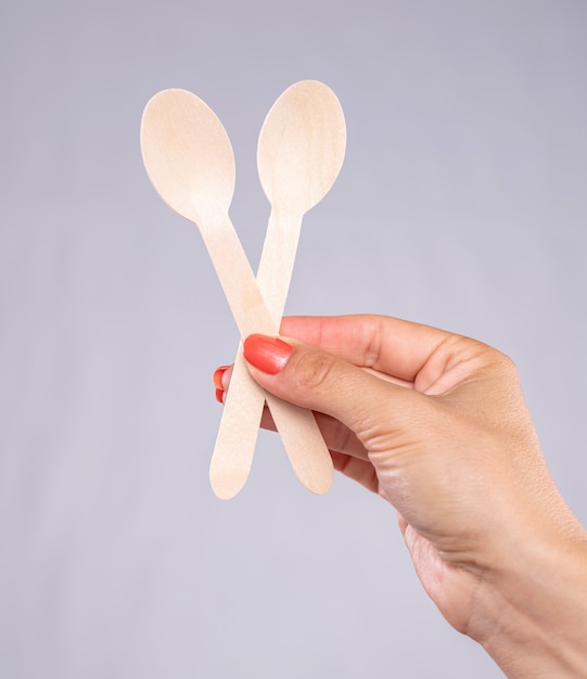 Plastic free concept. Woman holding wooden spoons