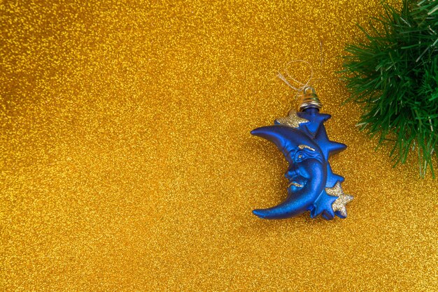 Plastic and glitter Christmas ornaments and Christmas garland on a gold glitter surface. selective focus.