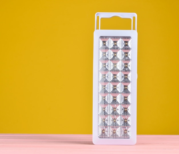 Plastic led flashlights on yellow background