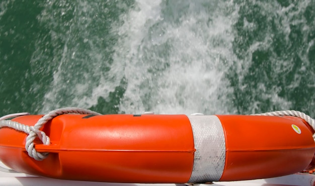 plastic life preserver of a boat seen from above with water in the background