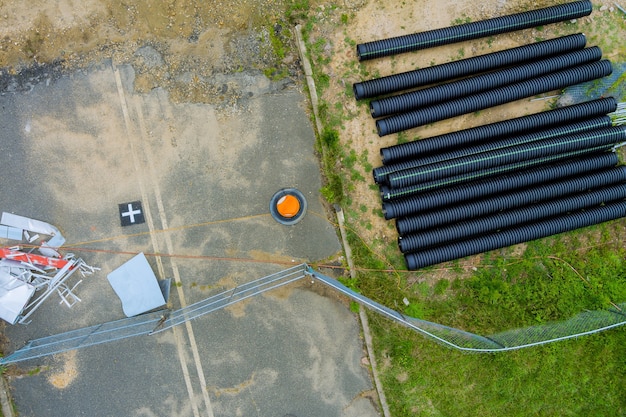 Photo plastic main black pipes on heap of polyethylene pipes for a water supply system for laying urban communications of home