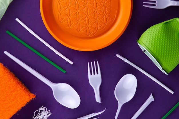 Plastic orange green waste collection on purple 