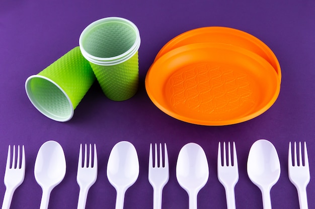 Plastic orange green waste collection on purple